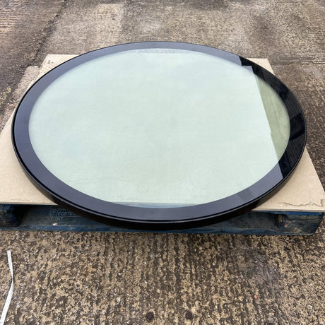a glass well cover ontop of a pallet