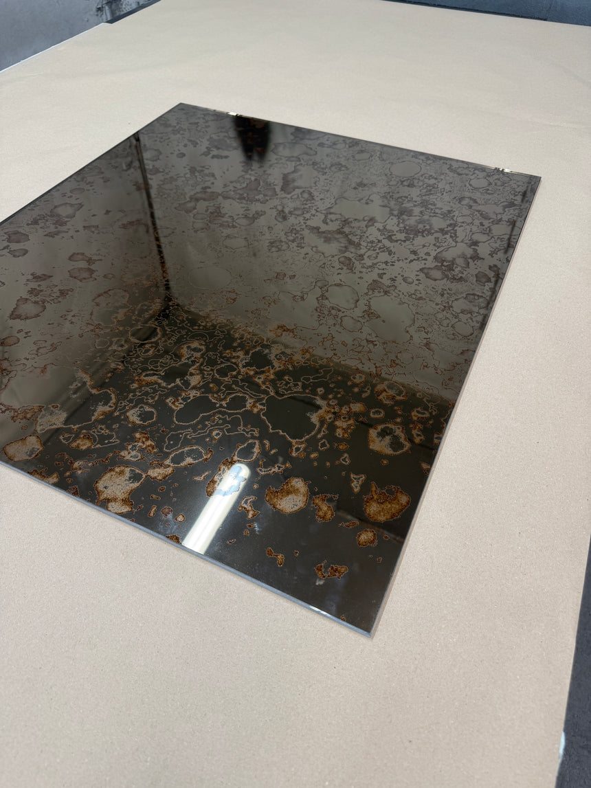 A side angle of a bronze antique mirror splashback on a light background