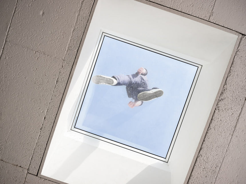 A view from below of a person walking over a walk on glass skylight